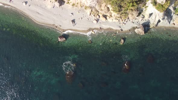 Aerial View From Above on Calm Azure Sea and Volcanic Rocky Shores