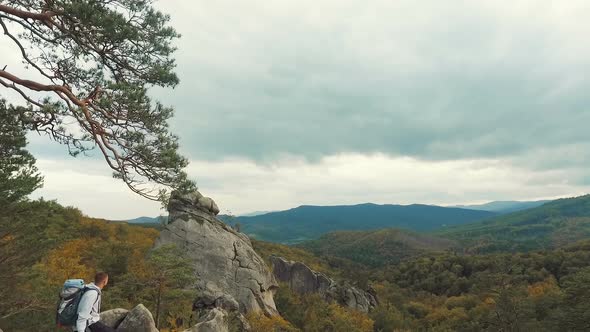 Man Looks at Highest Rocks