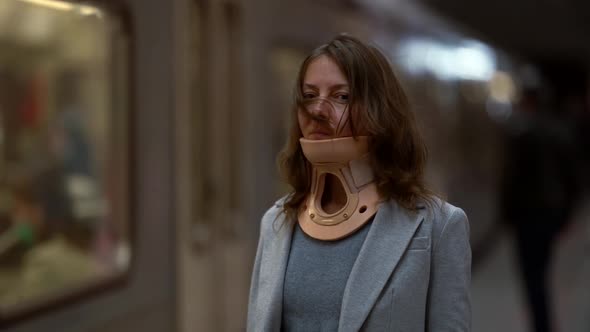 Woman with Cervical Collar in Underground Station, Portrait Shot, Osteochondrosis and Osteoporosis