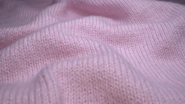 Cozy sheep wool pink fabric texture in macro. Handcraft knitting woolen sweater