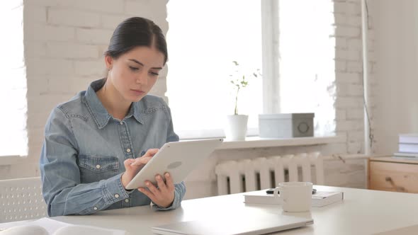 Young Girl Browsing Internet on Tablet