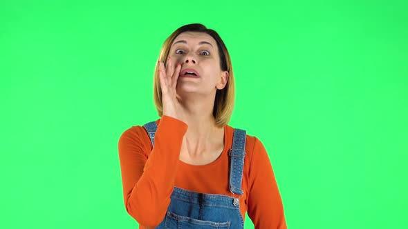 Girl Screams Calling Someone on a Green Screen at Studio
