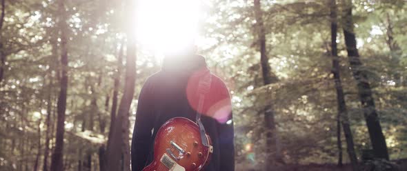 Guitar Player in the Woods