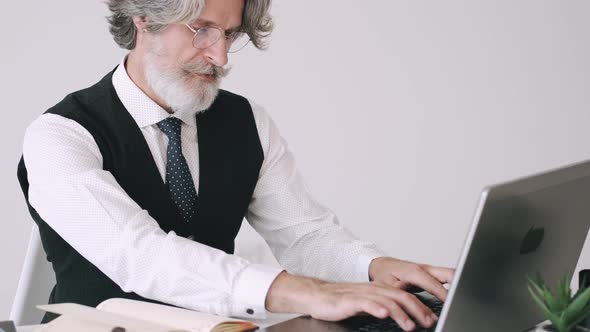 Hippie Businessman Working at the Office with Laptop