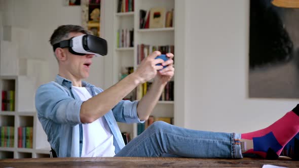 Middle Aged Caucasian Man Freelancer Wearing Virtual Reality Goggles During Working Break