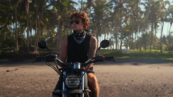 Man Biker Relaxing on Sandy Tropical Coast