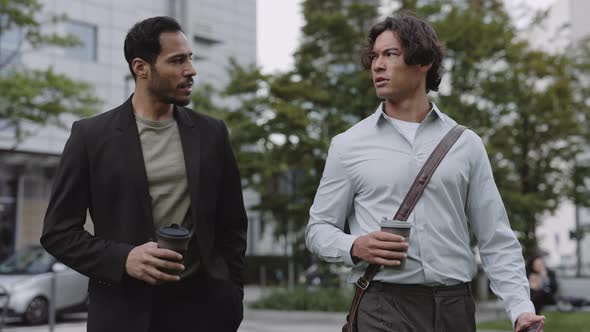 Asian and African American Men Walking and Talking on Street