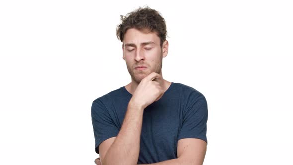 Portrait of Brunette Thoughtful Guy in Tshirt Thinking and Choosing Best Option Isolated Over White