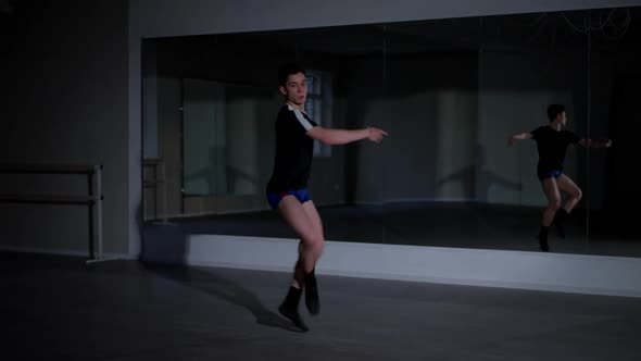 Confident Male Ballet Dancer Jumping Spinning and Smiling Looking at Camera Sitting Down