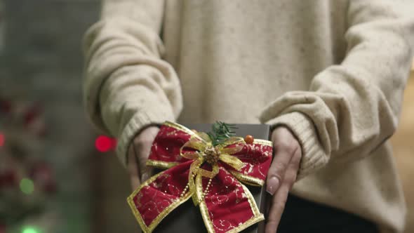 Close Up of Young Woman Holding a Christmas Gift