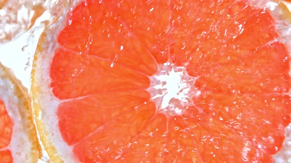 Super Slow Motion Shot of Splashing Water To Grapefruit Slices at 1000Fps