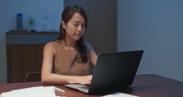 Woman work on computer at night