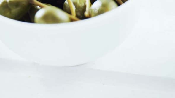 Green olives with stem in a bowl