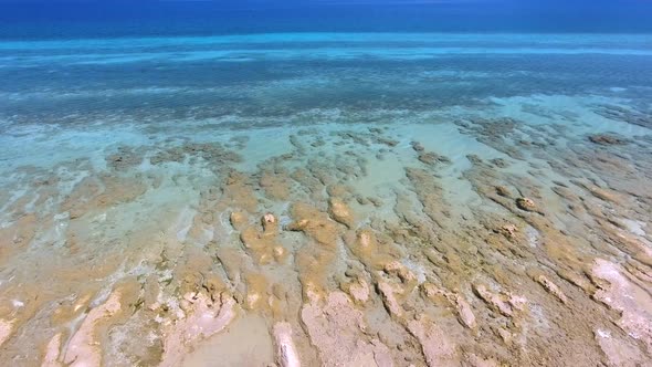 White Sandy Coral Reef in the Clear Turquoise Light Blue Sea of the Tropical Coastline