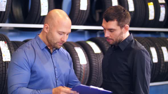 Customer and Salesman at Car Service or Auto Store 