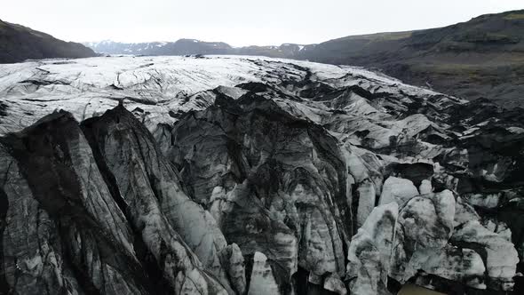 Iceland Glacier Drone flying above edge of glacier where it meets glacial lagoon