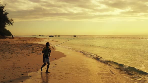 Fishing for cool traveller on holiday spends quality time at beach on paradise white sand and blue b