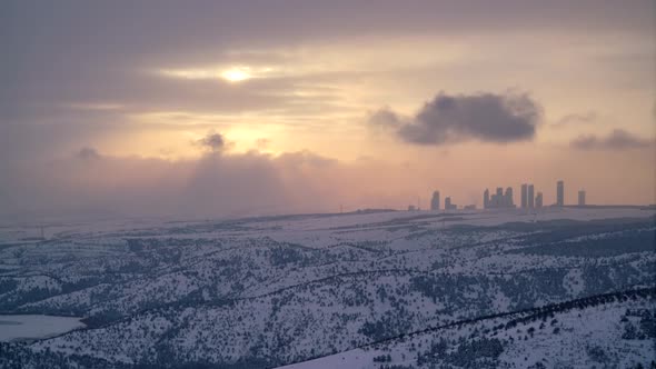 8K Sunset on Modern City Skyscrapers at The Edge of The Snowy Forest in Winter