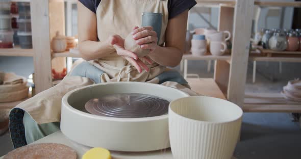 Female Potter Starts Work with Clay on Pottery Wheel.