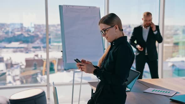 Businesswoman using mobile phone at workplace