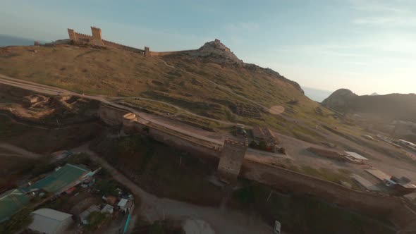 Fpv Cinematic Sport Drone Shooting Sudak City Sunset Landscape and Ancient Fortress Along Mountain