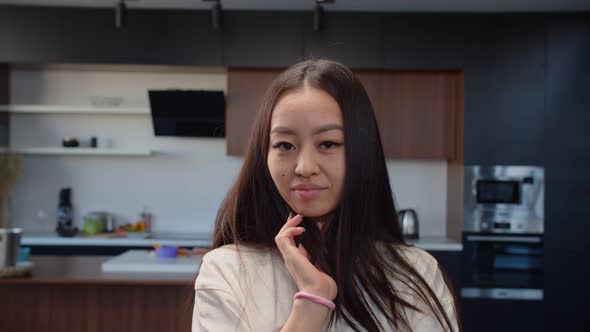 Portrait of Pretty Asian Woman Flirting in Home Interior