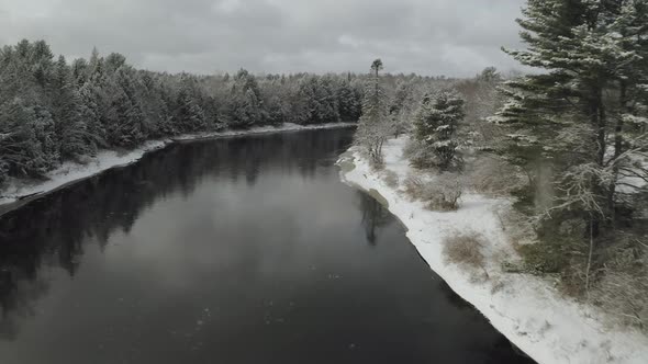 Forest covered with snow along Piscataquis river. Maine. USA. Aerial