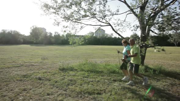 Following Two Senior Nordic Walkers