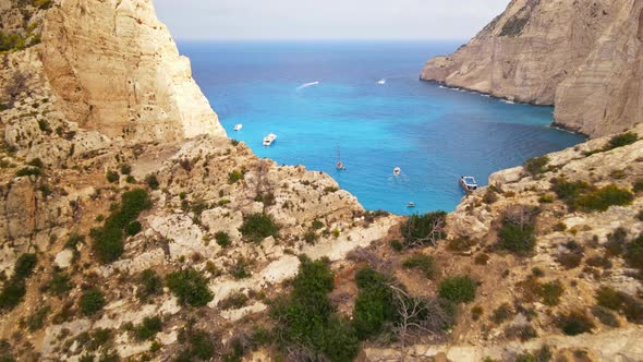 Aerial drone view of the Navagio beach on the Ionian Sea coast of Zakynthos, Greece. Moored boat