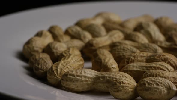 Cinematic, rotating shot of peanuts on a white surface - PEANUTS 014