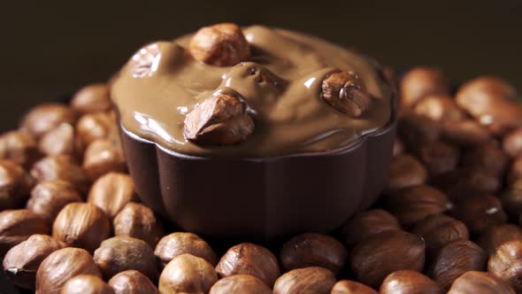 Pouring Hot Melted Chocolate and Almond Nuts Texture Close Up