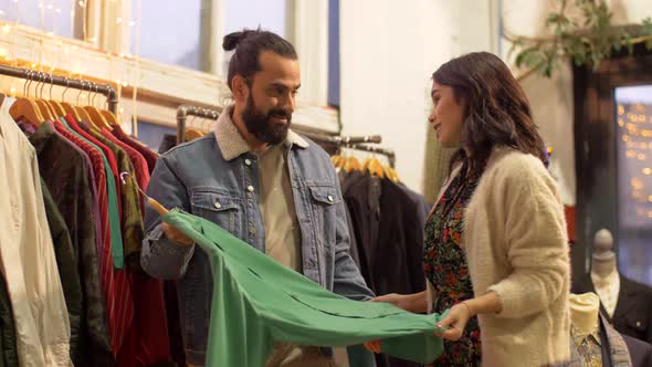 Couple Choosing Clothes at Vintage Clothing Store 