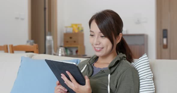 Woman watch on tablet computer at home