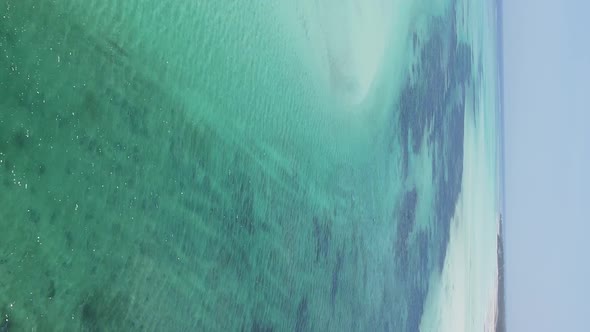 Vertical Video of the Ocean Near the Coast of Zanzibar Tanzania Aerial View