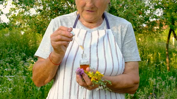 Old Woman Makes Herbal Tincture