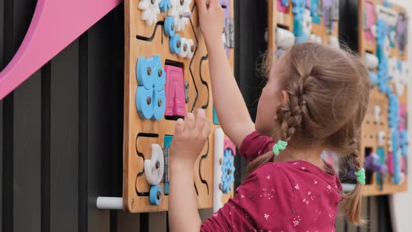 Cute Little Girl Playing Puzzle Game Outdoors