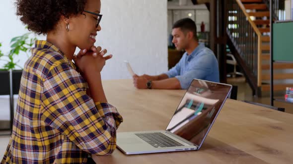 African American businesswoman using laptop in a modern office 4k