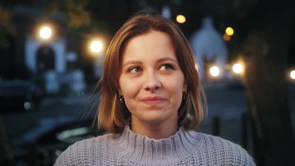 Close up portrait of a smartly young woman smiling and looking into the camera.