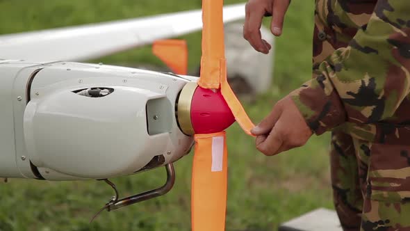 Man Takes Off Covers From Propeller of Commercial Aerial Surveillance or Military Aircraft. Military