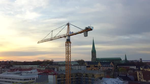 Aerial view of construction site of new residential building wint tower crane.