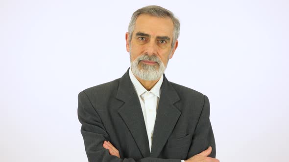 An Elderly Man Looks Seriously at the Camera - White Screen Studio