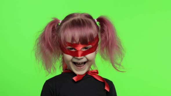 Funny Child Girl in Costume and Mask Plays Super Hero. National Superhero Day