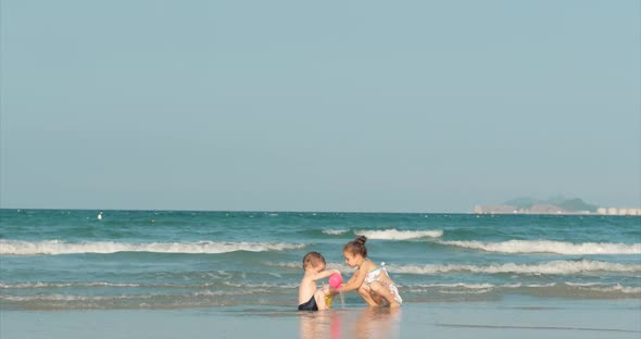 Happy and Carefree Children Playing By the Sea with Sand. Children Playing, Brother and Sister Play