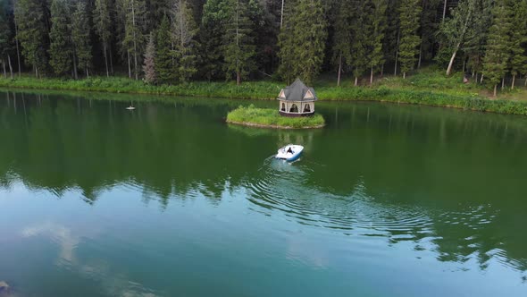 Aerial Shot, Summer Wooden House on Isolated Island in Lake in Green Forest