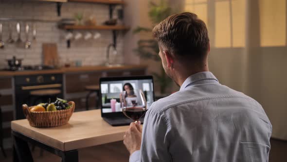 Man and Woman Drinking Wine During Online Date