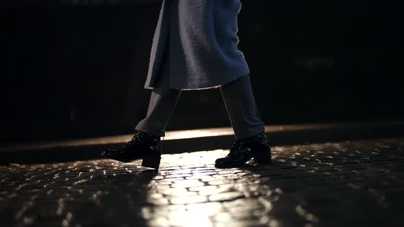 Night Walk in City Closeup View of Female Legs Strolling Over Cobblestone Road