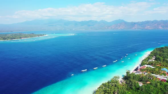 Daytime drone abstract shot of a white sandy paradise beach and aqua blue ocean background in colorf