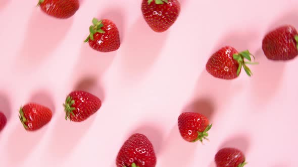 Fresh strawberries on pink background