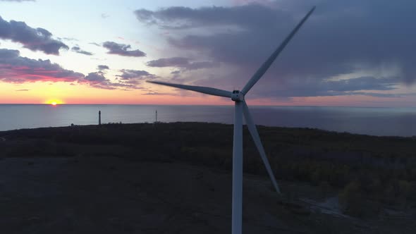 Aerial View of Wind Turbine on Sea Coast at Sunset