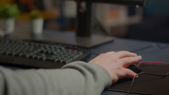 Closeup of Man Hands Gamer Playing Video Game Using RGB Keyboard